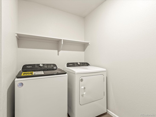 clothes washing area with independent washer and dryer