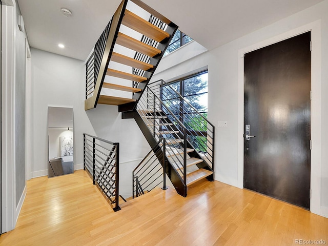 entryway with a high ceiling and hardwood / wood-style flooring