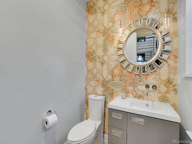 bathroom featuring vanity and toilet