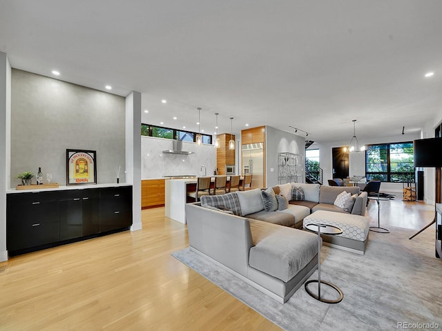 living room with light hardwood / wood-style flooring and an inviting chandelier