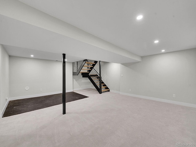 basement featuring light colored carpet