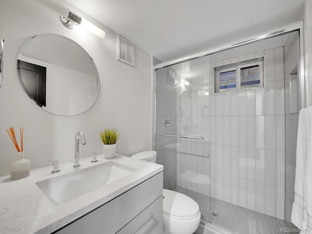 bathroom featuring vanity, toilet, and walk in shower