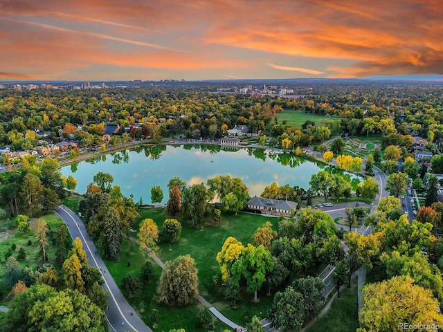 aerial view at dusk featuring a water view