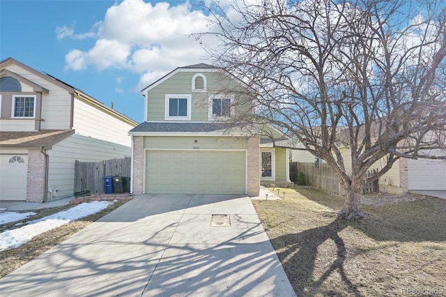 view of front of house with a shingled roof, concrete driveway, an attached garage, fence, and brick siding