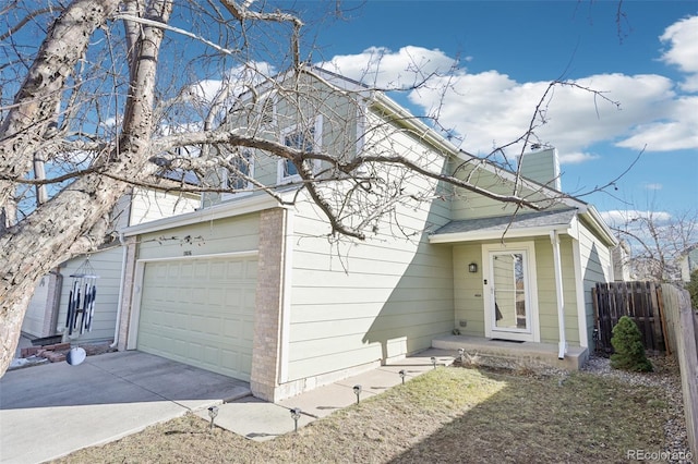 view of front of home with a garage, brick siding, fence, concrete driveway, and a chimney