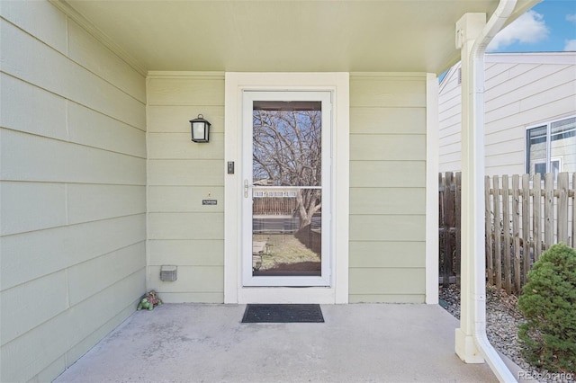 doorway to property with fence