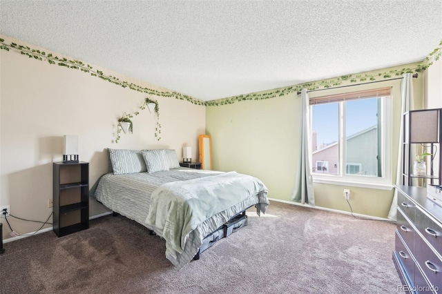 carpeted bedroom featuring baseboards and a textured ceiling