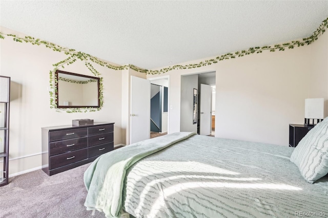 bedroom featuring a textured ceiling, carpet, and baseboards