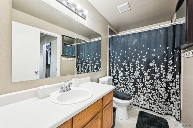 bathroom with visible vents, toilet, a shower with curtain, tile patterned flooring, and vanity