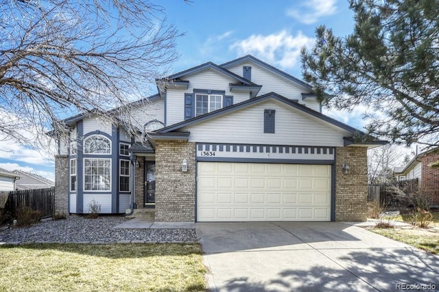 traditional home featuring concrete driveway, brick siding, an attached garage, and fence