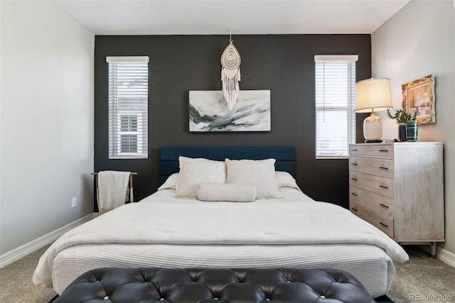 bedroom with carpet floors, baseboards, and multiple windows