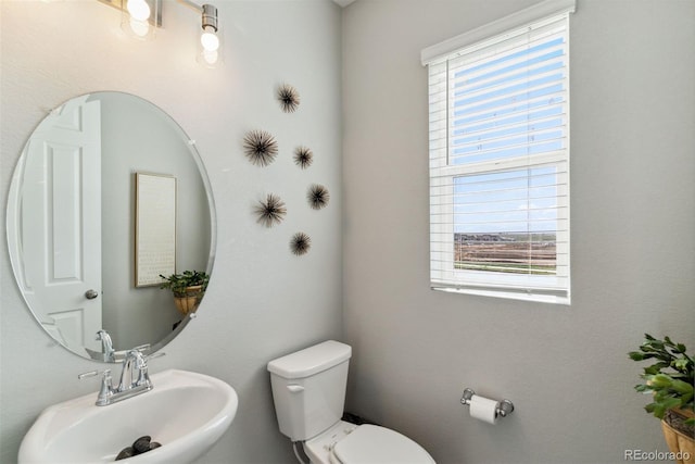 half bath featuring a sink and toilet