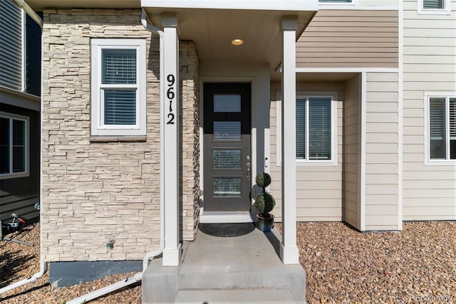 entrance to property featuring stone siding