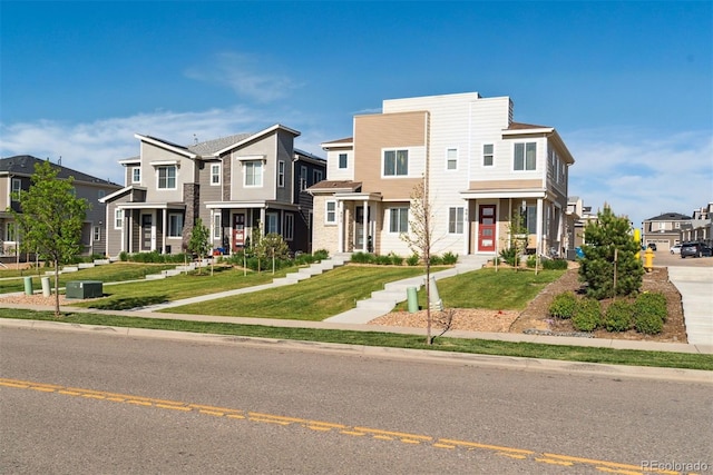 townhome / multi-family property with a residential view and a front yard