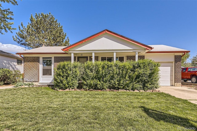 11816 Spring Dr, Northglenn, CO 80233 - view of front of property with a garage, a front yard, brick siding, and driveway