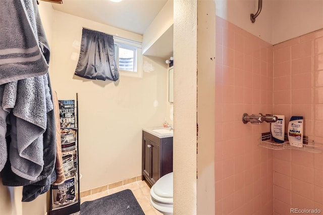 11816 Spring Dr, Northglenn, CO 80233 - bathroom featuring vanity, tiled shower, and toilet
