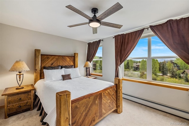 131 Creek Ln, Silverthorne, CO 80498 - bedroom with a baseboard heating unit, light colored carpet, and a ceiling fan