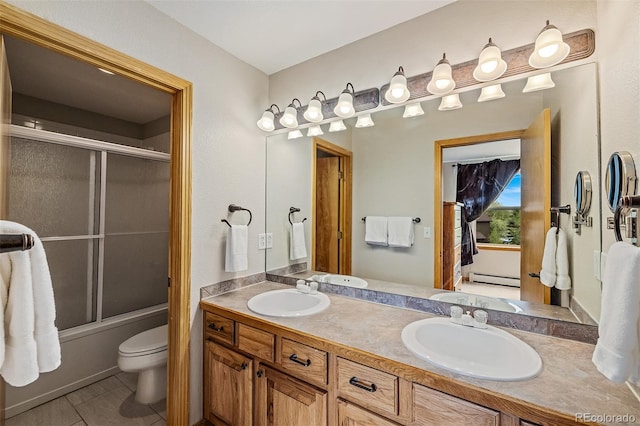 131 Creek Ln, Silverthorne, CO 80498 - bathroom with a baseboard heating unit, double vanity, and enclosed tub / shower combo
