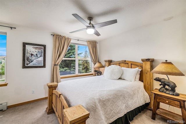 131 Creek Ln, Silverthorne, CO 80498 - bedroom with light carpet, ceiling fan, and a baseboard heating unit