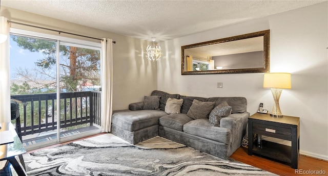 living room with a textured ceiling and wood finished floors