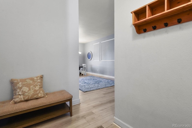 mudroom featuring light wood-type flooring and baseboards