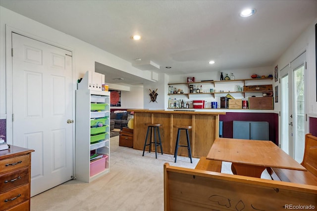 22379 E Dorado Ave, Aurora, CO 80015 - kitchen featuring light colored carpet, open shelves, a breakfast bar area, and recessed lighting