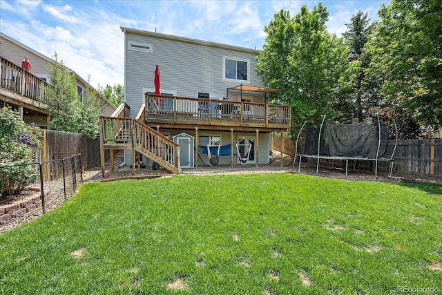 22379 E Dorado Ave, Aurora, CO 80015 - rear view of property with a trampoline, a deck, and stairway