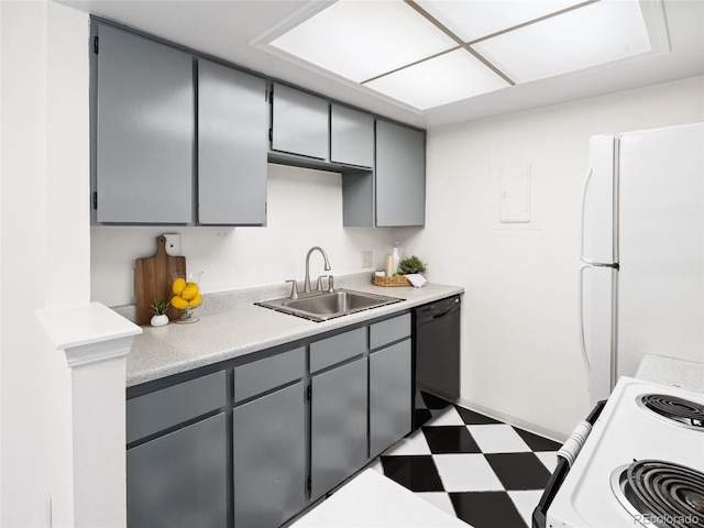 kitchen with a sink, white appliances, gray cabinets, tile patterned floors, and light countertops