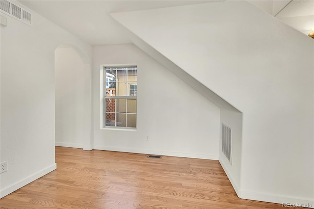 bonus room featuring lofted ceiling and light hardwood / wood-style flooring