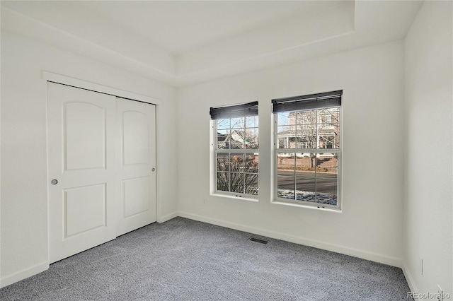 unfurnished bedroom featuring carpet flooring and a closet