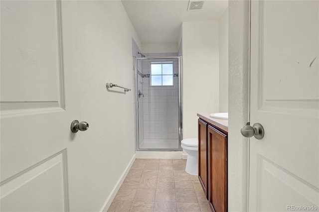 bathroom featuring tile patterned flooring, vanity, an enclosed shower, and toilet