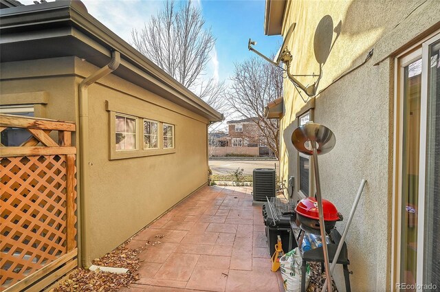 view of home's exterior with a patio area and cooling unit