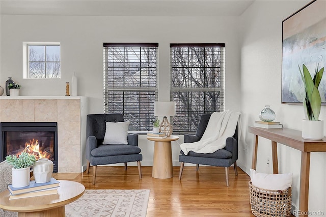 sitting room featuring a fireplace and hardwood / wood-style floors