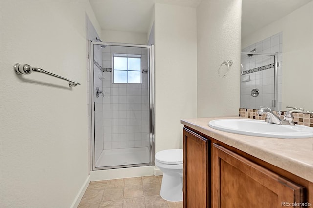 bathroom featuring vanity, toilet, and a shower with door