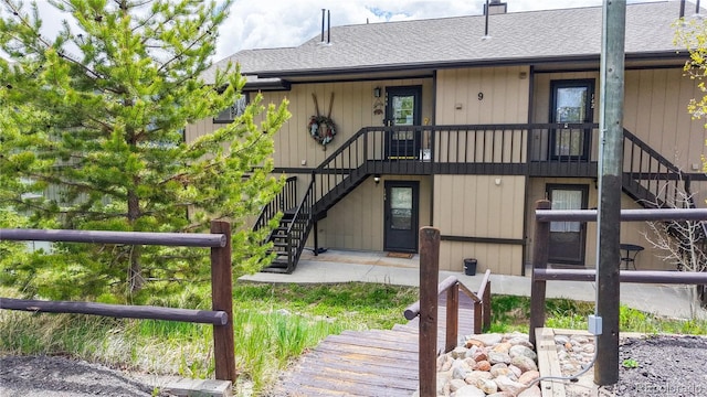 144 Tall Pine Cir, Grand Lake, CO 80447 - rear view of house with stairway and roof with shingles