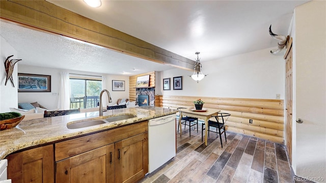 144 Tall Pine Cir, Grand Lake, CO 80447 - kitchen with dishwasher, a sink, open floor plan, wood finished floors, and rustic walls