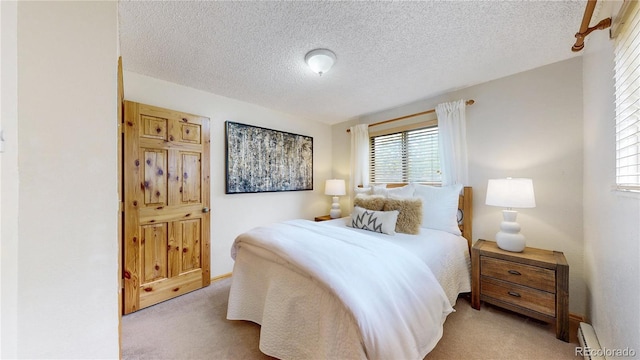 144 Tall Pine Cir, Grand Lake, CO 80447 - carpeted bedroom with multiple windows, a baseboard radiator, and a textured ceiling