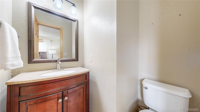 144 Tall Pine Cir, Grand Lake, CO 80447 - half bath with toilet, vanity, and a textured wall