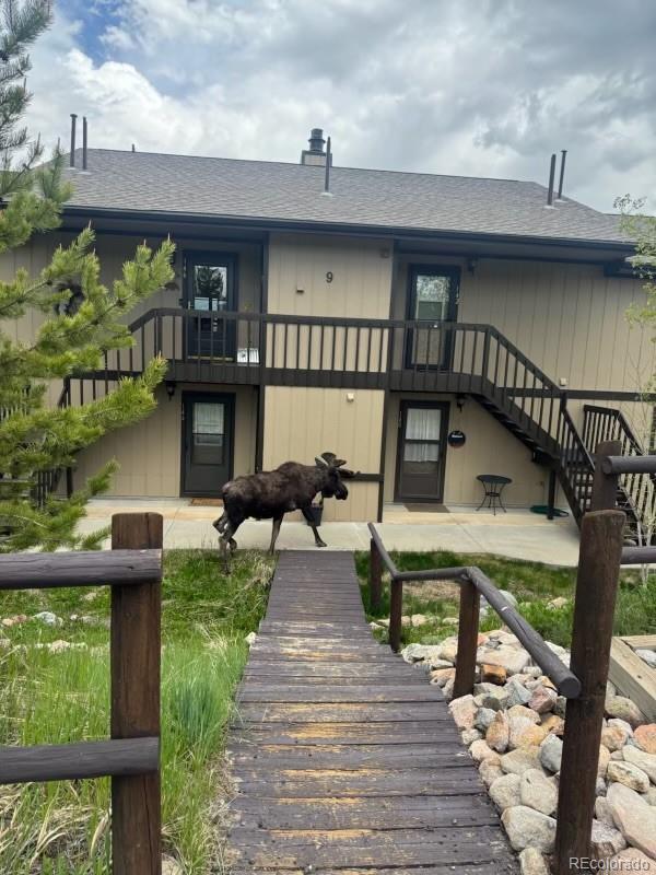 144 Tall Pine Cir, Grand Lake, CO 80447 - back of property with roof with shingles, a balcony, and stairway