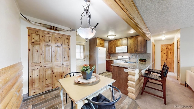 144 Tall Pine Cir, Grand Lake, CO 80447 - dining room featuring light wood-style floors and a textured ceiling