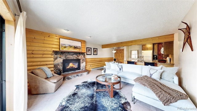 144 Tall Pine Cir, Grand Lake, CO 80447 - living area with rustic walls, a textured ceiling, a fireplace, and a baseboard radiator