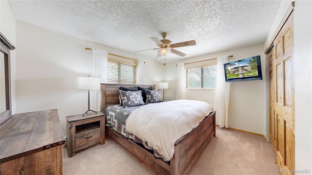 144 Tall Pine Cir, Grand Lake, CO 80447 - bedroom with light colored carpet, a textured ceiling, a ceiling fan, and baseboards