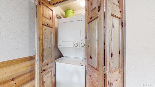 144 Tall Pine Cir, Grand Lake, CO 80447 - washroom with stacked washer / drying machine and a textured wall