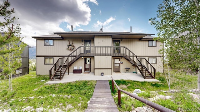 144 Tall Pine Cir, Grand Lake, CO 80447 - back of property with stairway and a patio area