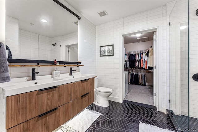 bathroom featuring vanity, toilet, and tile walls