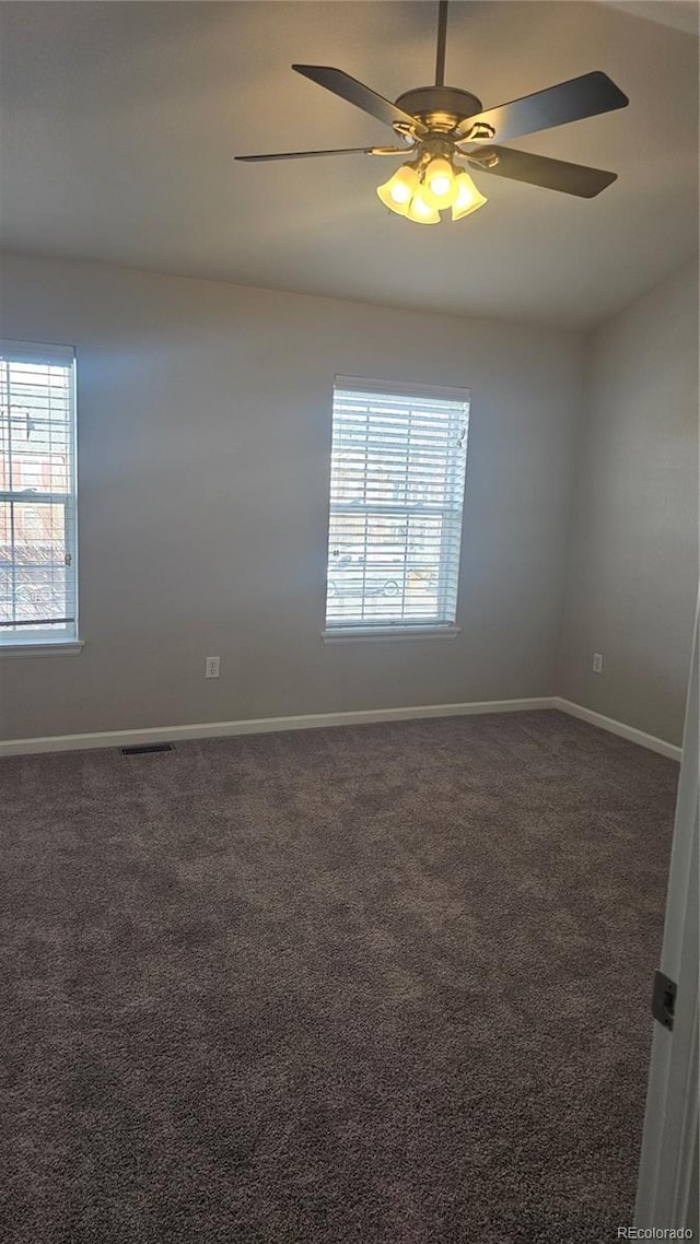 carpeted spare room with ceiling fan