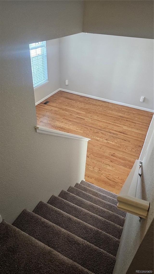 stairway featuring wood-type flooring