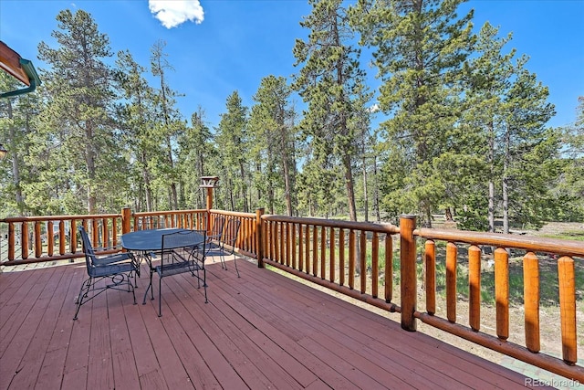 wooden terrace featuring outdoor dining space