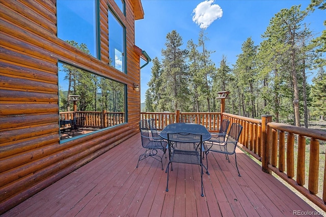 wooden terrace with outdoor dining area