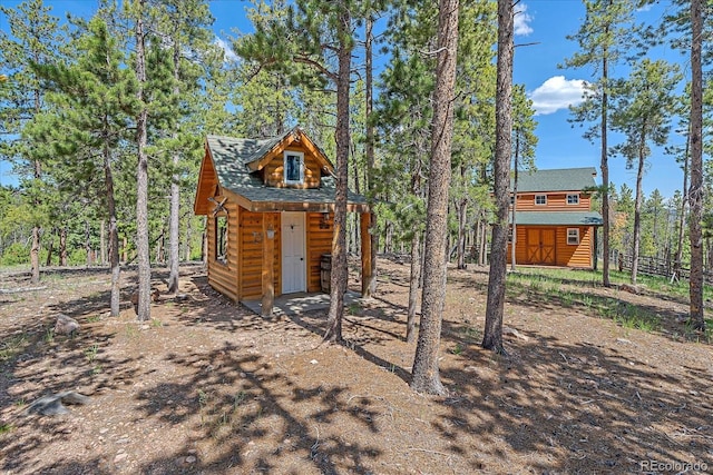 view of outbuilding featuring an outbuilding and fence